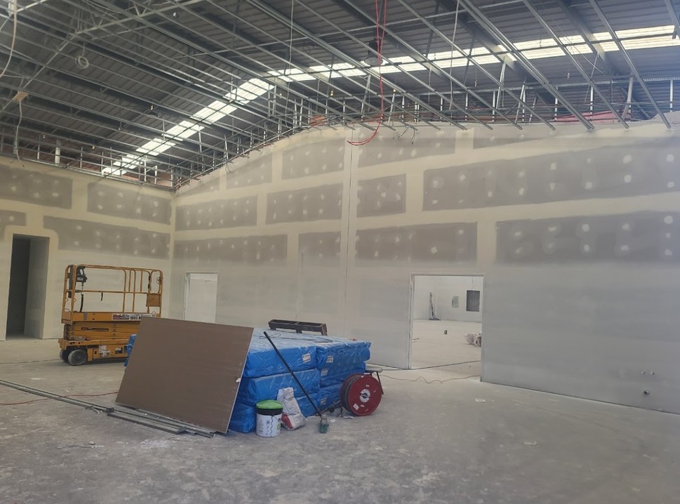 Steel stud framing and a suspended ceiling going up in a commercial space