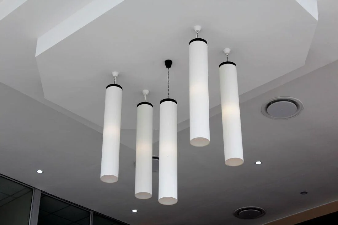 Pendant lights hanging from a smooth plastered ceiling